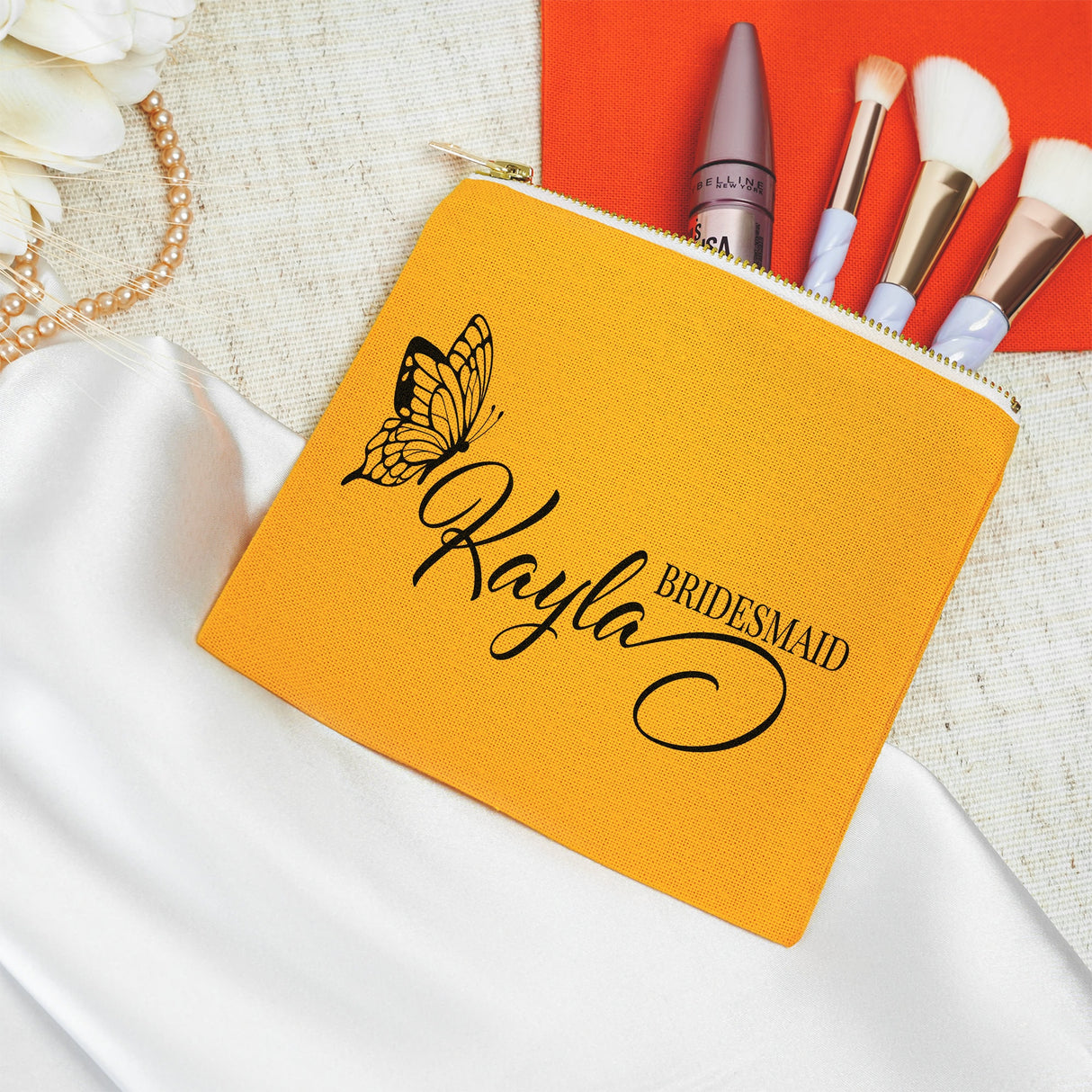 a yellow bridesmaid pouch with makeup brushes