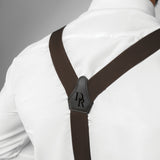 a man wearing a white shirt and brown suspenders