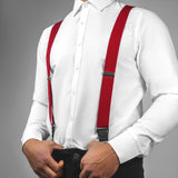 a man wearing a white shirt and red suspenders