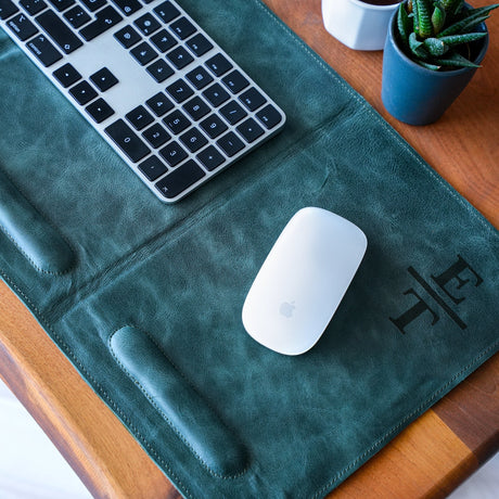 a keyboard and mouse pad on a table