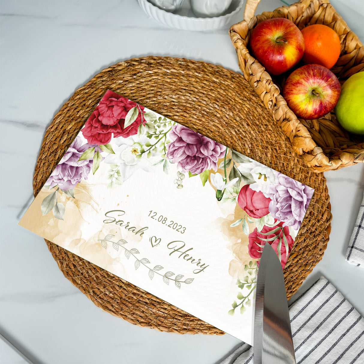 a table with a basket of fruit and a place card