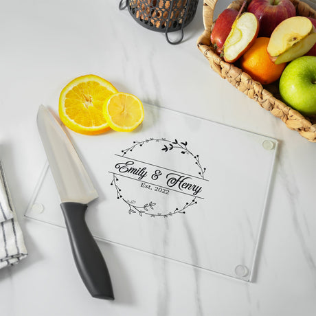 a cutting board sitting on top of a counter next to a knife