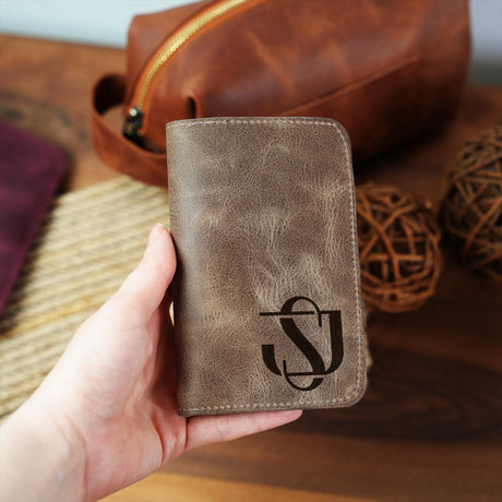 a person holding a brown leather wallet