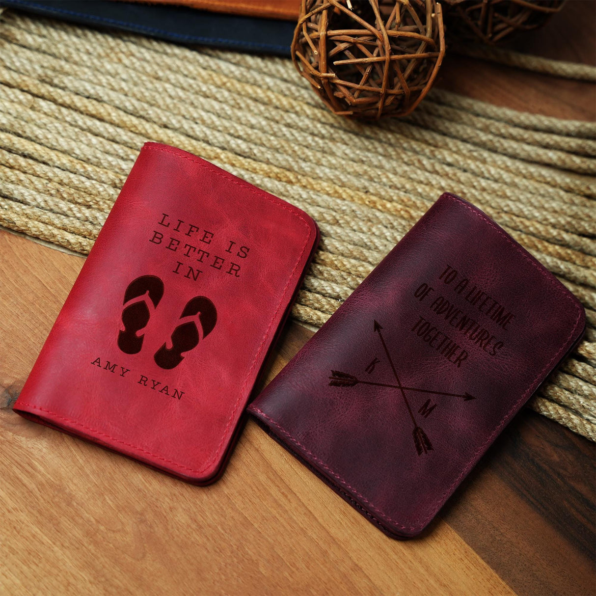 a couple of passport covers sitting on top of a wooden table