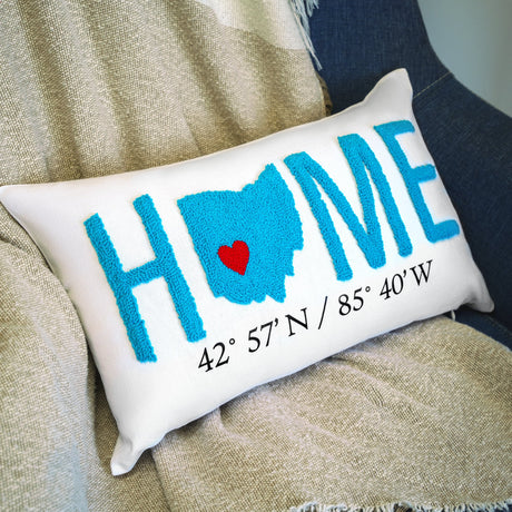 a pillow with a heart on it sitting on a couch