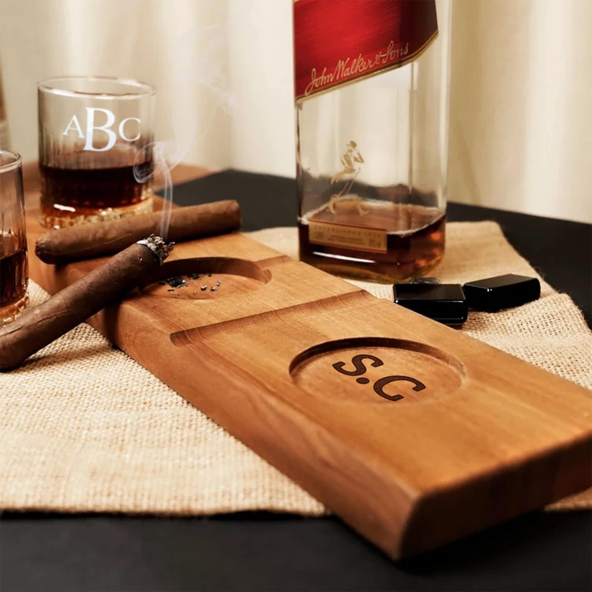 a wooden cutting board with a bottle of whiskey and a cigar