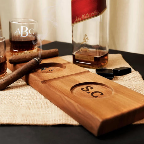 a wooden cutting board with a bottle of whiskey and a cigar