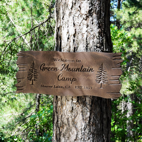 a sign on a tree that says green mountain camp