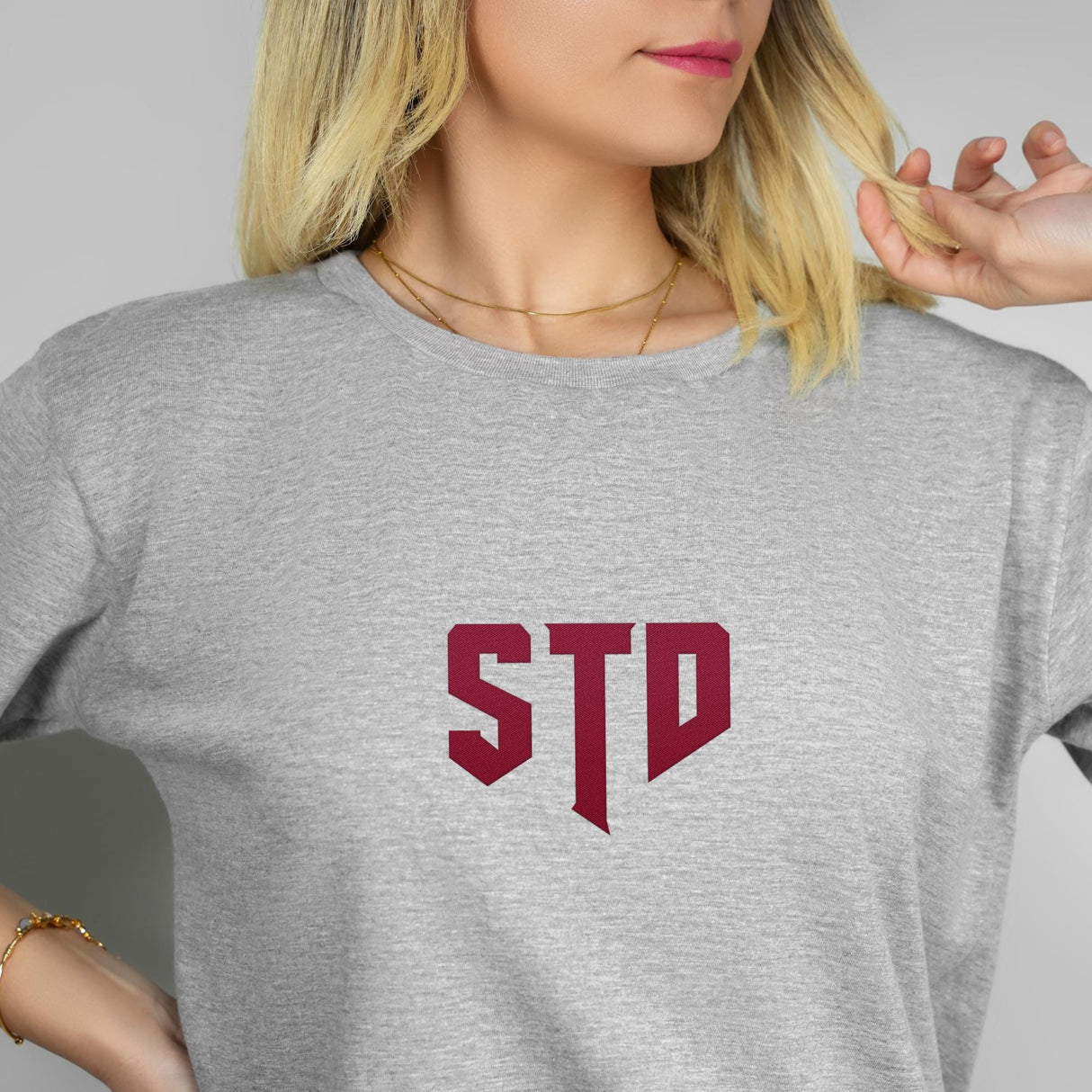 a woman with blonde hair wearing a std t - shirt