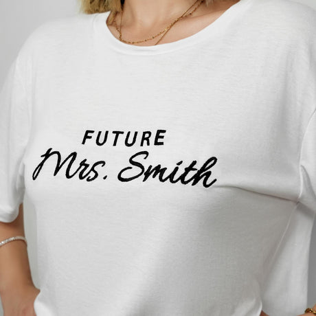 a woman wearing a white t - shirt that says future mrs smith