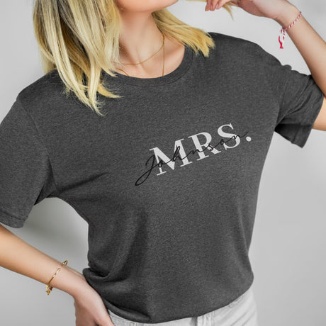 a blonde woman wearing a grey mrs t - shirt