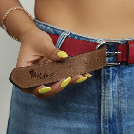 a woman is holding a belt with yellow nails on it