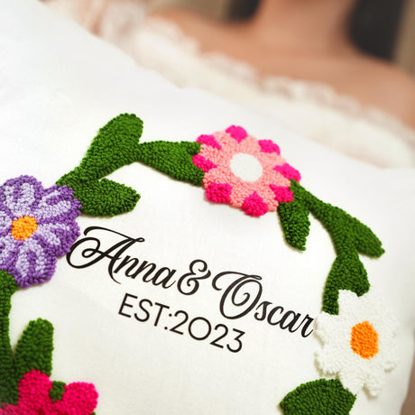 a close up of a pillow with flowers on it