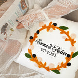 a personalized pillow with a wreath on it