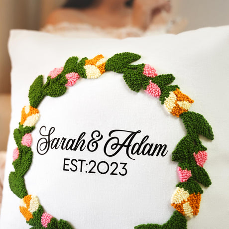 a white pillow with a crocheted wreath on it