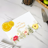 a card with an orange slice and flowers on it