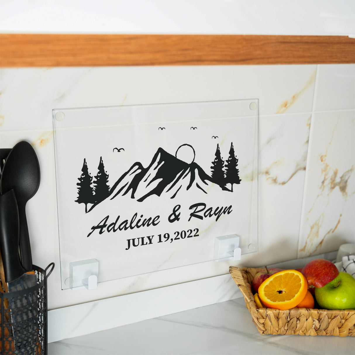 a kitchen counter with a basket of fruit and utensils