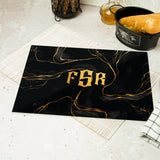 a black and gold place mat with the word fer on it