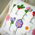 a close up of a pillow with flowers on it