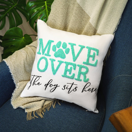 a pillow that says move over the dog sits here