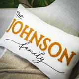 a white pillow with the name of a family on it