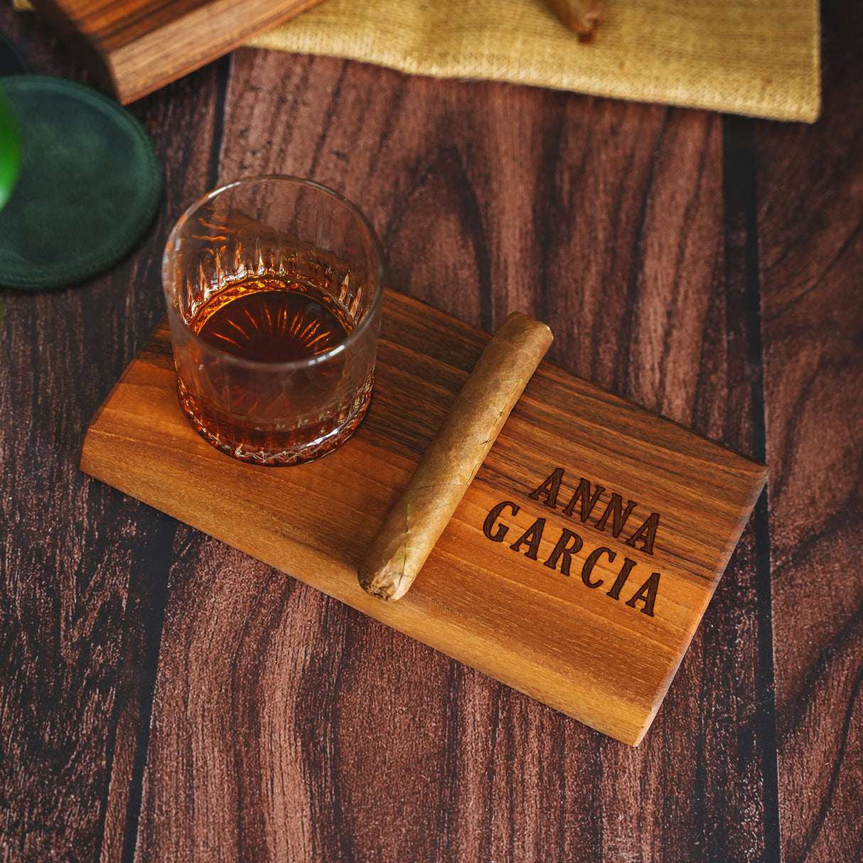 a wooden coaster with a glass of alcohol on it