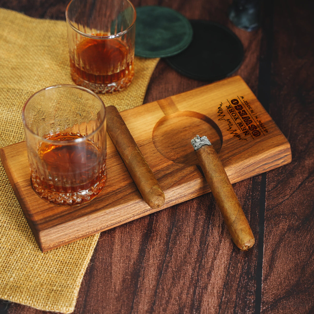 a wooden cutting board with a glass of whiskey on it