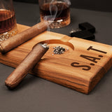 a cigar sitting on top of a wooden cutting board