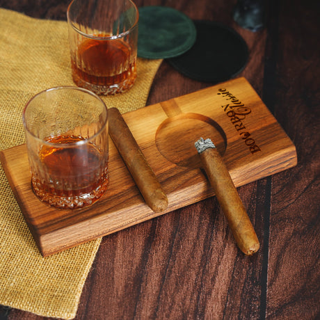 a wooden cutting board with a glass of whiskey on it