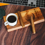 a cup of coffee sitting on top of a wooden coaster