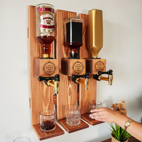 a person is holding a glass in front of a wall mounted beer dispense