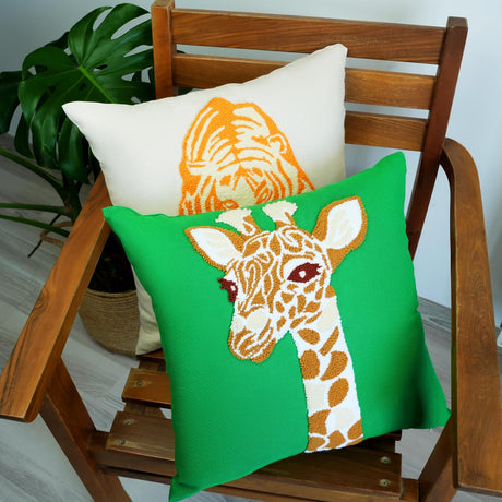 a wooden chair with two pillows with a giraffe on them