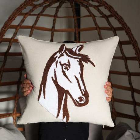 a person holding a pillow with a horse drawn on it