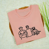 a pink t - shirt with a picture of a man and a dog on it