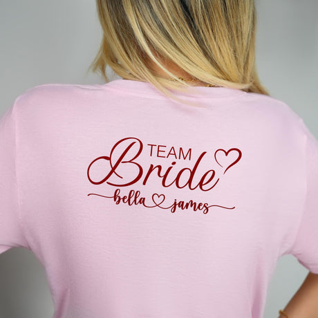 a woman wearing a pink team bride t - shirt