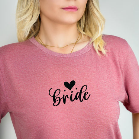 a woman wearing a pink shirt with the word bride printed on it