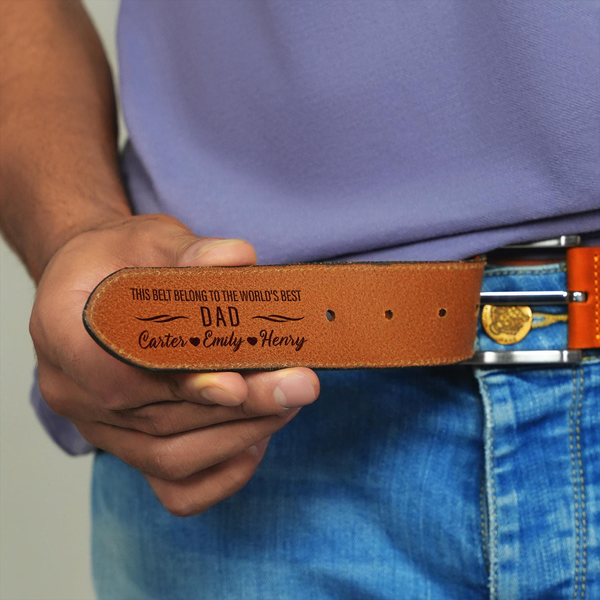 a man is holding a belt with a message on it