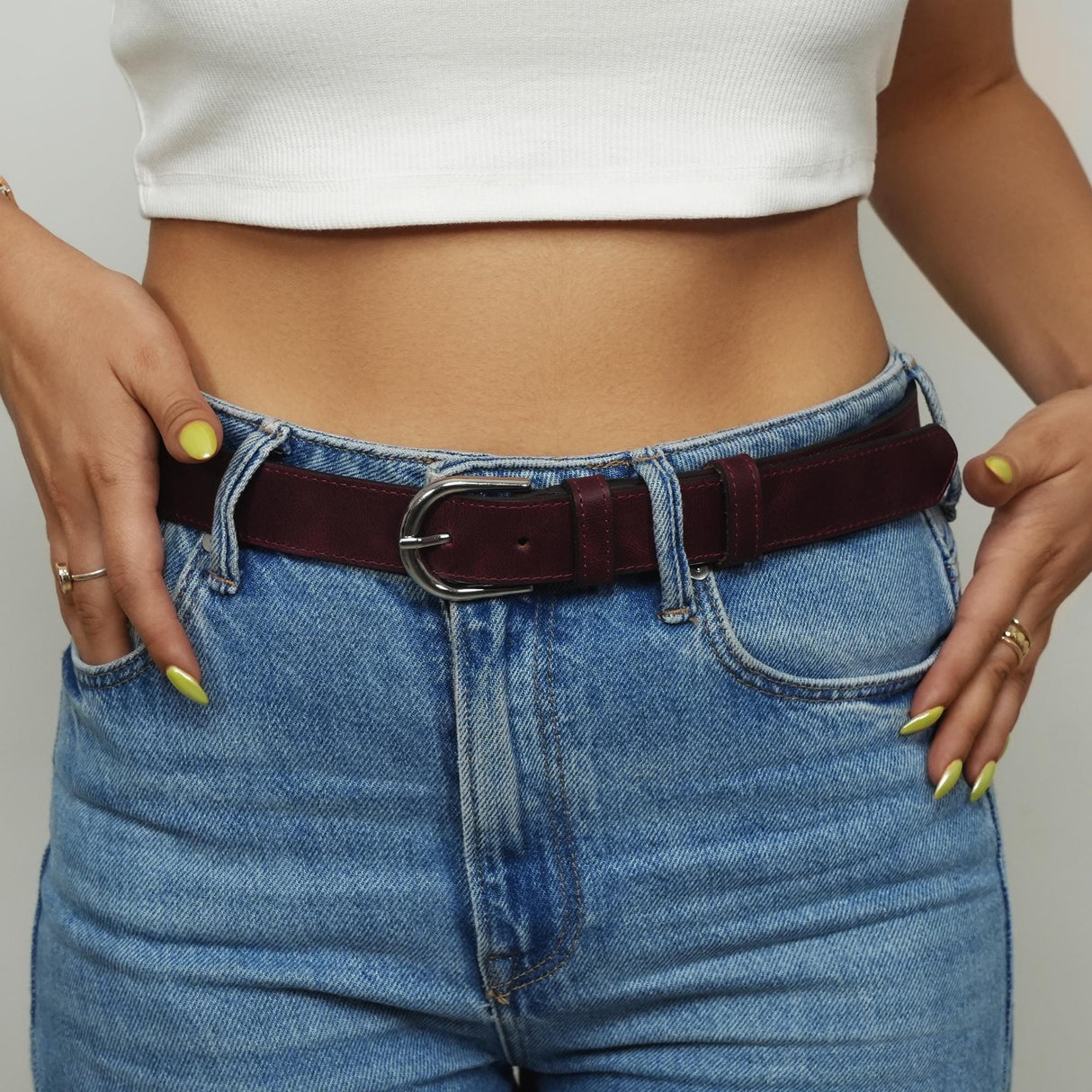 a woman wearing a white top and jeans