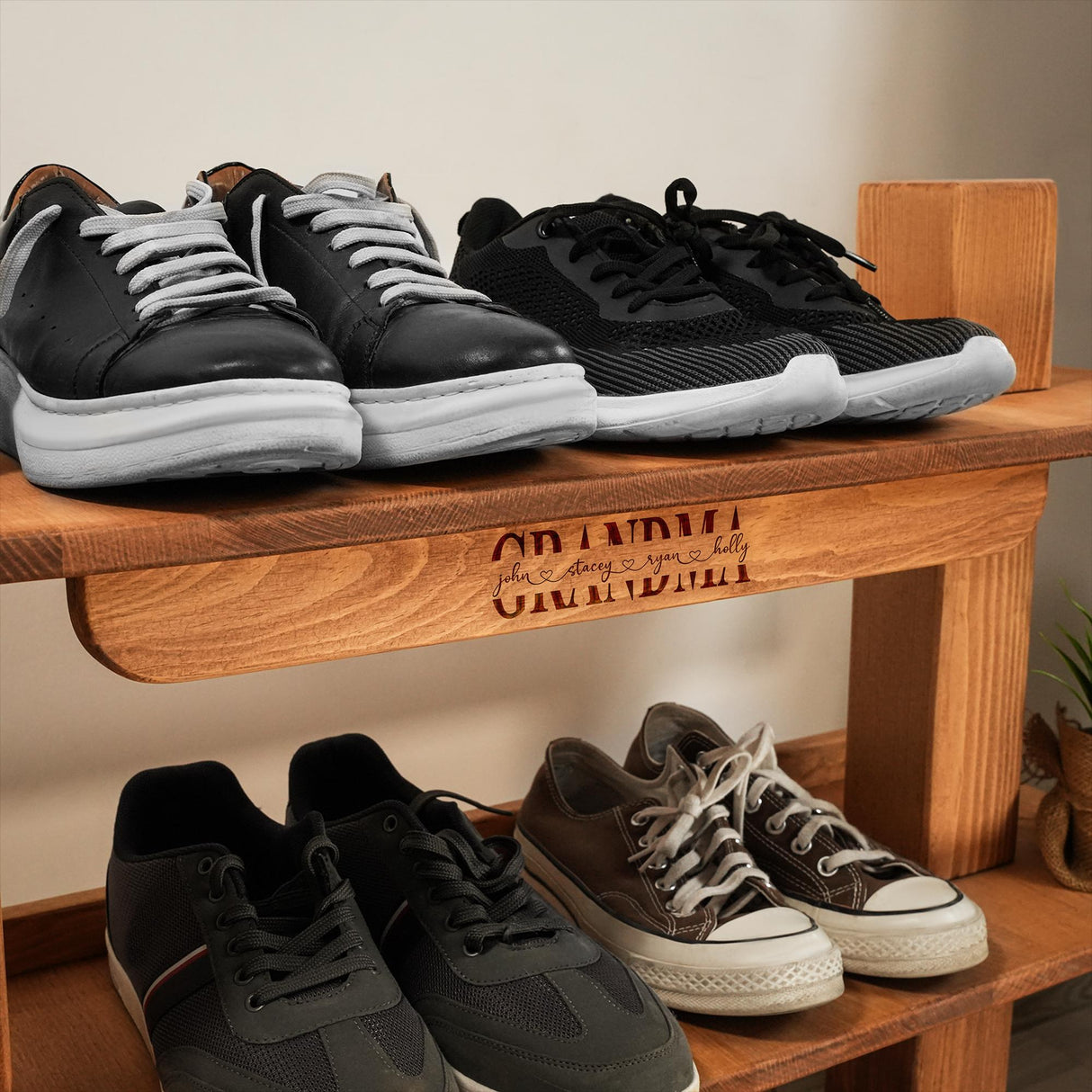 three pairs of shoes are on a wooden shelf