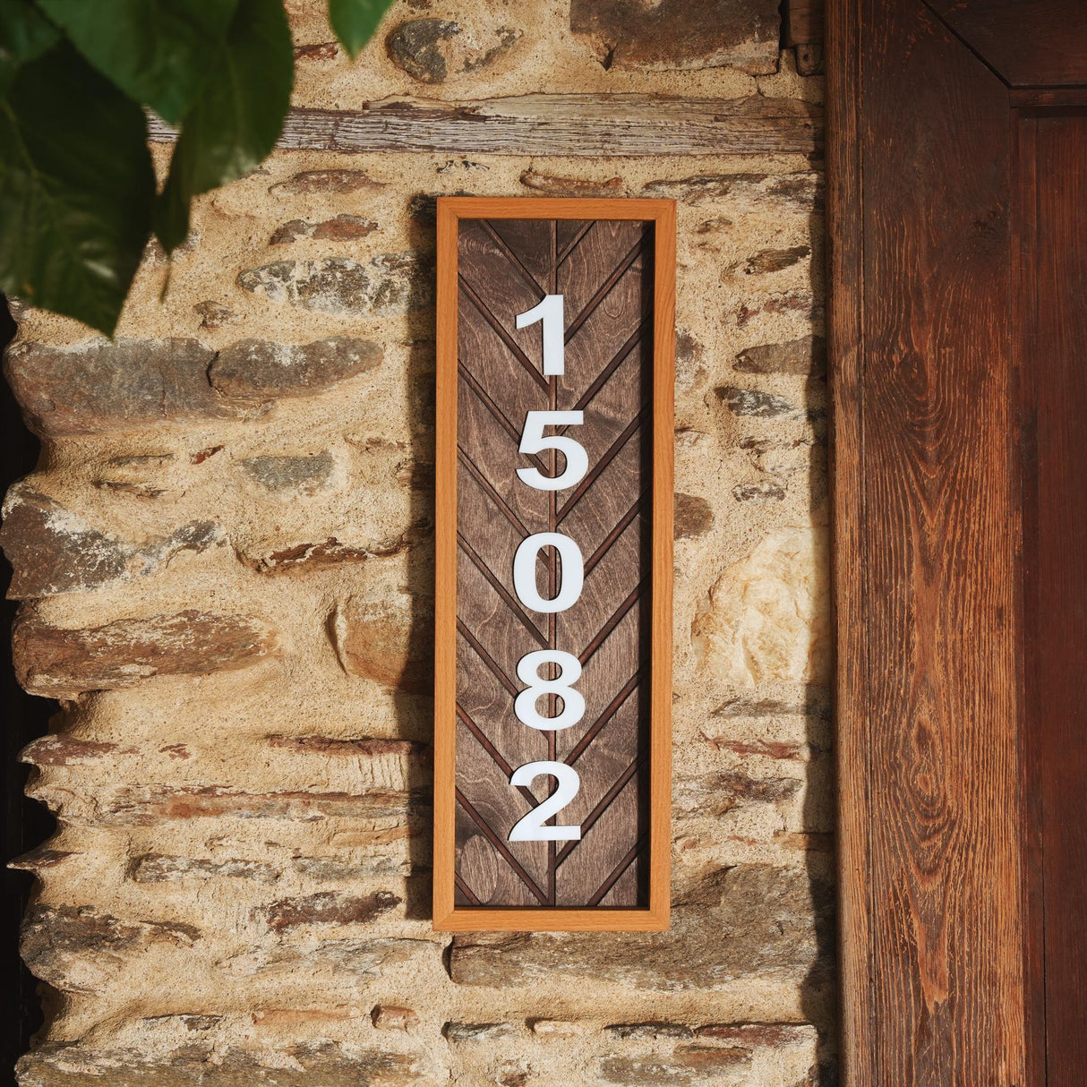 a house number sign on a stone wall