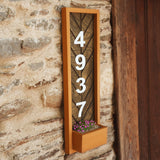 a house number sign mounted to the side of a building