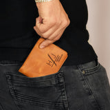 a person holding a wallet in their pocket