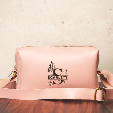 a pink purse sitting on top of a wooden table