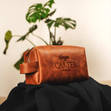 a brown leather bag sitting on top of a black cloth