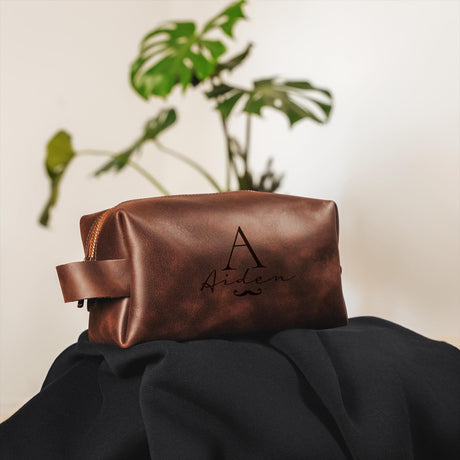 a leather pouch with a monogrammed initials on it