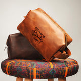 a brown bag sitting on top of a wooden stool