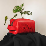 a red bag sitting on top of a black cloth