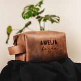 a brown leather bag with a name on it