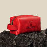 a red bag sitting on top of a rock