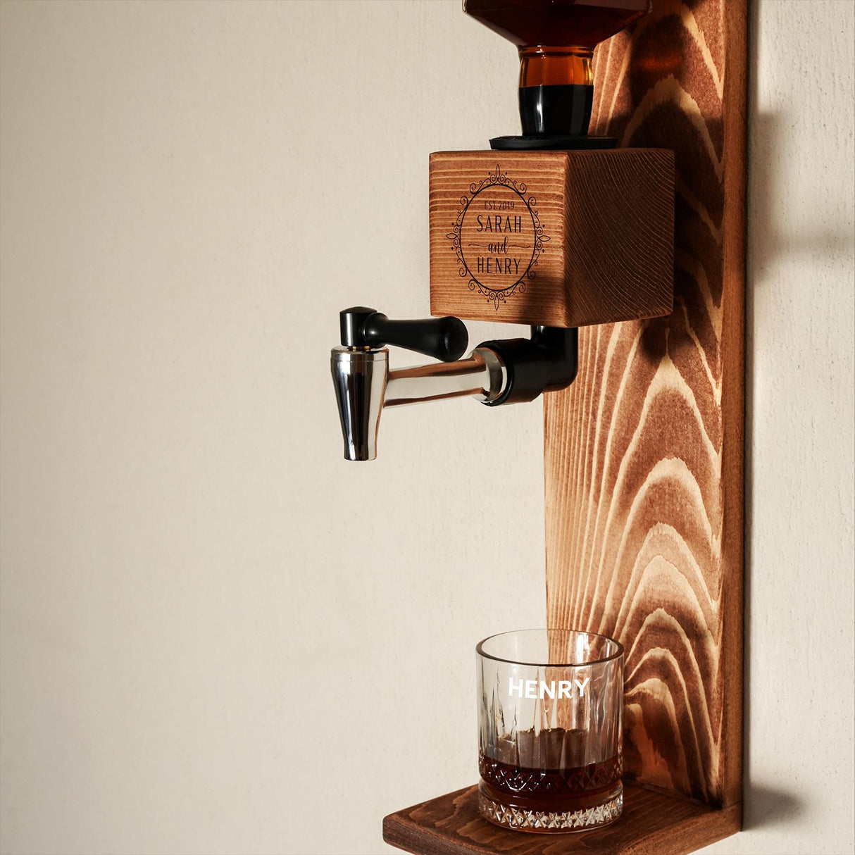 a wooden shelf holding a shot glass and a coffee maker